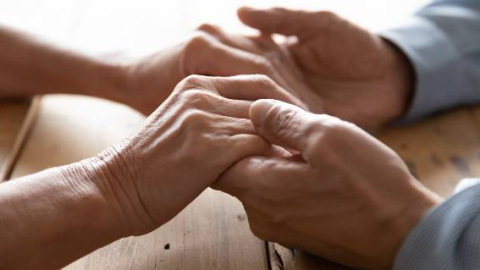 Close-up of couple man and woman holding hands