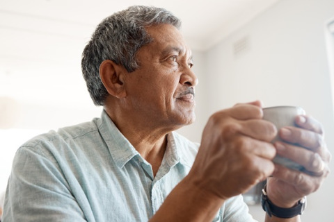 man drinking coffee at home